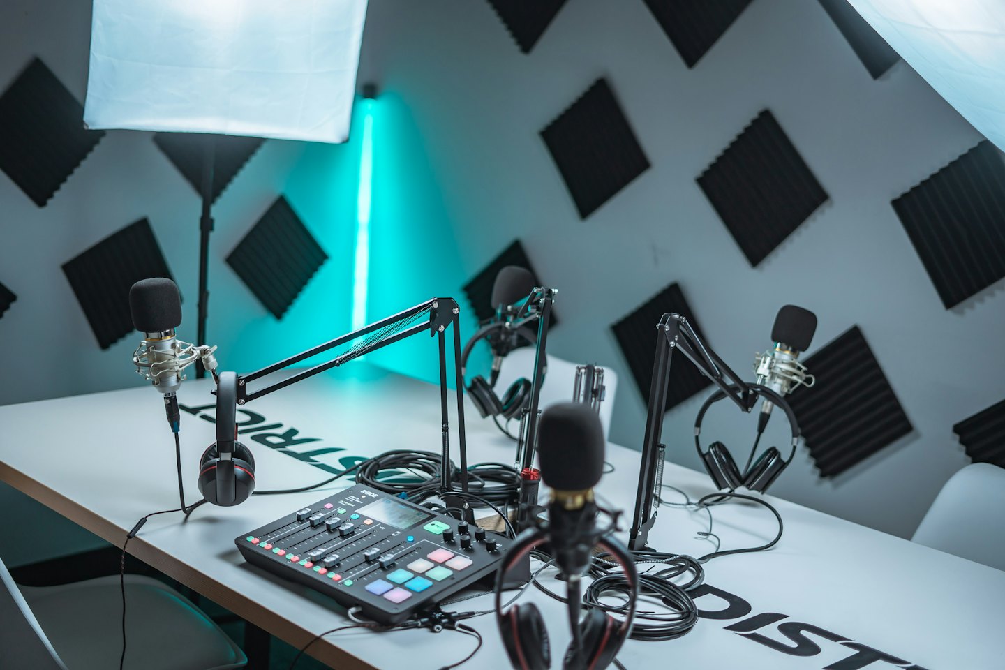 Studio de podcast avec microphones, casque et table de mixage audio.